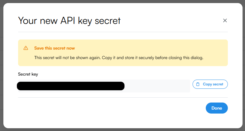 Your new API key secret dialog. A yellow Save this secret now warning explains the secret will not be shown again. Below the warning, a Secret key field displays the new secret with a Copy secret button. A blue Done button sits in the bottom-right.